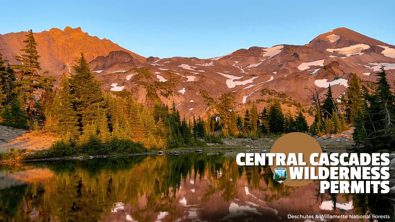 Mountain lake at sunset with forest and snow-capped peaks, text reads Central Cascades Wilderness Permits.